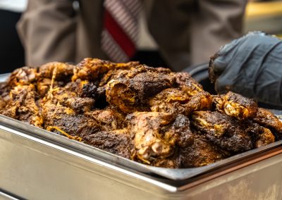 Community members in formal attire laughing and connecting around decorated tables at the Community Gala 2025.