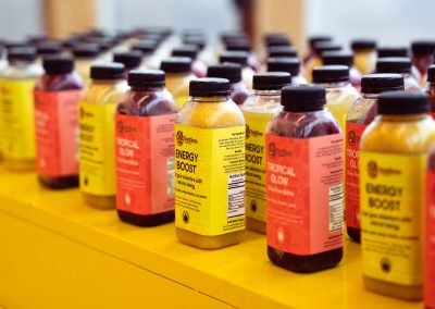 Community members in formal attire laughing and connecting around decorated tables at the Community Gala 2025.