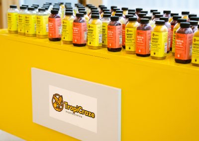 Community members in formal attire laughing and connecting around decorated tables at the Community Gala 2025.