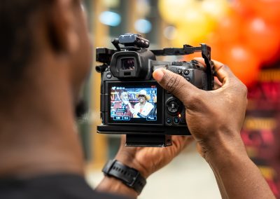 Community members in formal attire laughing and connecting around decorated tables at the Community Gala 2025.
