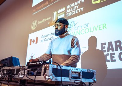Community members in formal attire laughing and connecting around decorated tables at the Community Gala 2025.