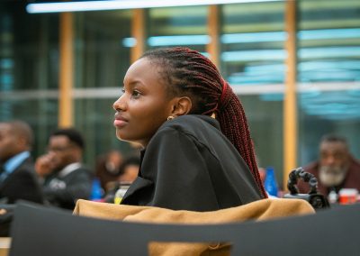 Community members in formal attire laughing and connecting around decorated tables at the Community Gala 2025.