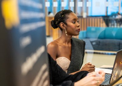 Community members in formal attire laughing and connecting around decorated tables at the Community Gala 2025.